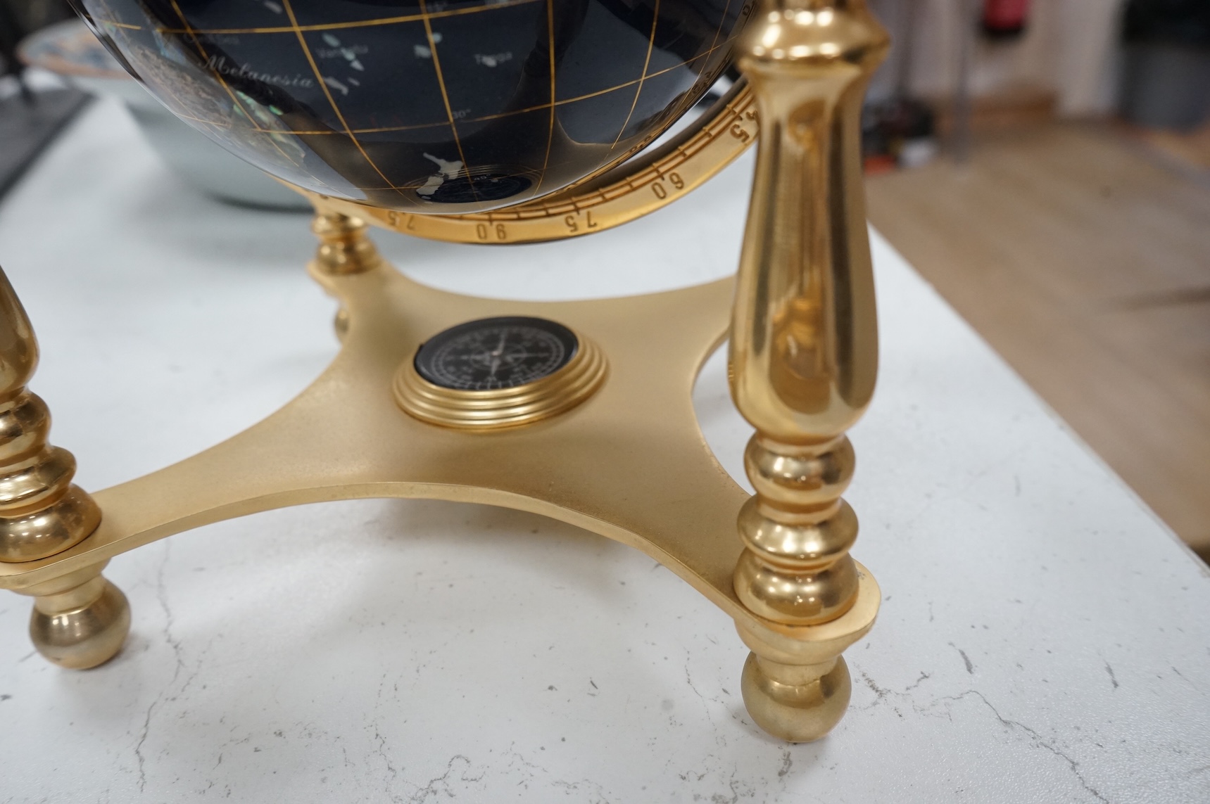 A table-top globe, on brass gimbal stand, 23cm in diameter